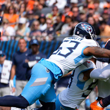 Chicago Bears running back Khalil Herbert (24) is taken down by Tennessee Titans linebacker Harold Landry III (58) and linebacker Ernest Jones IV (53) at Soldier Field in Chicago, Ill., Sunday, Sept. 8, 2024.