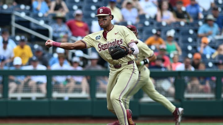 Jun 18, 2024; Omaha, NE, USA; Florida State Seminoles third baseman Cam Smith (24) throws to first base against the North Carolina Tar Heels during the first inning at Charles Schwab Field Omaha. 