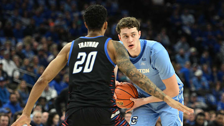 Feb 26, 2025; Omaha, Nebraska, USA;  Creighton Bluejays center Ryan Kalkbrenner (11) looks to pass against DePaul Blue Demons forward JJ Traynor (20) during the second half at CHI Health Center Omaha. Mandatory Credit: Steven Branscombe-Imagn Images