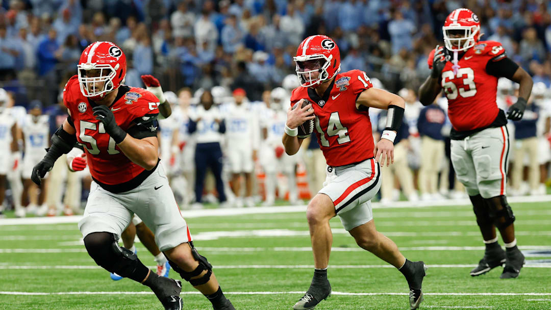 Jan 1, 2026; New Orleans, LA, USA; Georgia Bulldogs quarterback Gunner Stockton (14) scrambles for a touchdown against the Mississippi Rebels in the second quarter during the 2026 Sugar Bowl and quarterfinal game of the College Football Playoff at Caesars Superdome. Mandatory Credit: Geoff Burke-Imagn Images