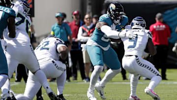 Oct 12, 2025; Jacksonville, Florida, USA; Jacksonville Jaguars defensive end Emmanuel Ogbah (90) tackles Seattle Seahawks running back Kenneth Walker III (9) during the first half at EverBank Stadium. Mandatory Credit: Travis Register-Imagn Images