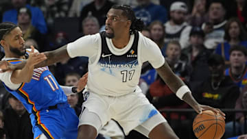Feb 13, 2025; Minneapolis, Minnesota, USA; Minnesota Timberwolves center Naz Reid (11) works against Oklahoma City Thunder guard Isaiah Joe (11) in the second quarter at Target Center. Mandatory Credit: Bruce Kluckhohn-Imagn Images