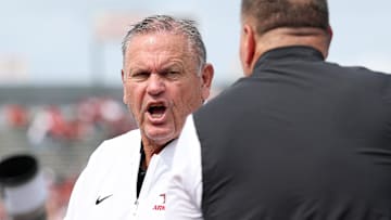 Arkansas Razorbacks coach Sam Pittman talks to Arkansas State Red Wolves coach Butch Jones prior to the game at War Memorial Stadium.