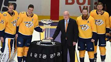 Apr 7, 2018; Nashville, TN, USA; (From left to right) Nashville Predators center Ryan Johansen (92) goalie Pekka Rinne (35)  defenseman Roman Josi (59) defenseman Ryan Ellis (4) defenseman Mattias Ekholm (14) and left wing Filip Forsberg (9) pose with NHL deputy commissioner Bill Daly as the Nashville Predators are awarded the Presidents' Trophy before the game against the Columbus Blue Jackets at Bridgestone Arena. Mandatory Credit: Christopher Hanewinckel-Imagn Images