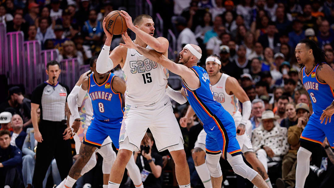 May 15, 2025; Denver, Colorado, USA; Denver Nuggets center Nikola Jokic (15) controls the ball under pressure form Oklahoma City Thunder guard Alex Caruso (9) in the second quarter during game six of the second round for the 2025 NBA Playoffs at Ball Arena. Mandatory Credit: Isaiah J. Downing-Imagn Images