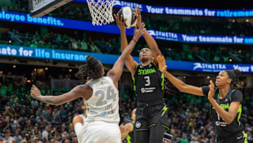 Jun 1, 2025; Seattle, Washington, USA;  Seattle Storm forward Nneka Ogwumike (3) takes the ball Las Vegas Aces guard Jewell Loyd (24) Seattle Storm center Dominique Malonga (14) in the fourth period at Climate Pledge Arena. 