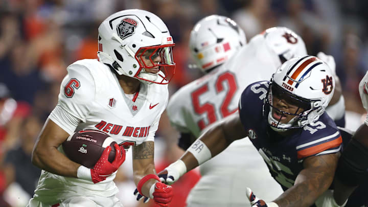 Sep 14, 2024; Auburn, Alabama, USA; Auburn Tigers defensive lineman Keldric Faulk (15) dives to tackle New Mexico Lobos running back Eli Sanders (6) during the second quarter at Jordan-Hare Stadium. Mandatory Credit: John Reed-Imagn Images
