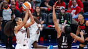 Sep 16, 2025; Indianapolis, Indiana, USA;  Atlanta Dream forward Nia Coffey (12) shoots the ball while Indiana Fever forward Brianna Turner (11) defends during game two of round one for the 2025 WNBA Playoffs at Gainbridge Fieldhouse. Mandatory Credit: Trevor Ruszkowski-Imagn Images