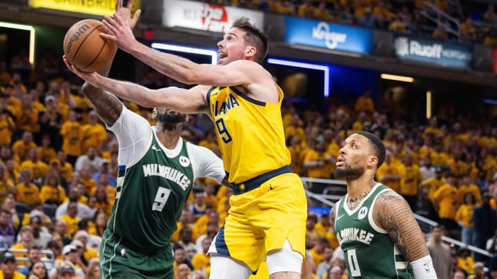 May 2, 2024; Indianapolis, Indiana, USA; Indiana Pacers guard T.J. McConnell (9) shoots the ball while Milwaukee Bucks guard Damian Lillard (0) defends during game six of the first round for the 2024 NBA playoffs at Gainbridge Fieldhouse. Mandatory Credit: Trevor Ruszkowski-USA TODAY Sports