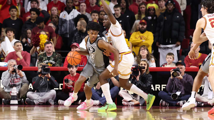 Jan 29, 2026; Ames, Iowa, USA;  Colorado Buffaloes guard Isaiah Johnson (2) is defended by Iowa State Cyclones guard Jamarion Batemon (1) during the first half at James H. Hilton Coliseum. Mandatory Credit: Reese Strickland-Imagn Images