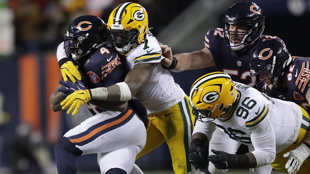 Dec 20, 2025; Chicago, Illinois, USA; Green Bay Packers linebacker Quay Walker (7) tacklles Chicago Bears running back D'Andre Swift (4) during their football game at Soldier Field. Mandatory Credit: Dan Powers