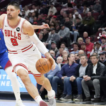Denver Nuggets center Nikola Jokic (15) defends Chicago Bulls center Nikola Vucevic (9) during the first half at United Center. Mandatory Credit: David Banks-Imagn Images