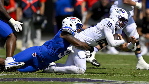 TCU quarterback Josh Hoover, right, is tackled by SMU defensive end Cameron Robertson on Sept. 20.