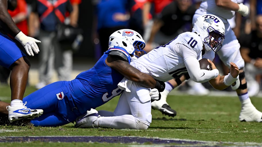 TCU quarterback Josh Hoover, right, is tackled by SMU defensive end Cameron Robertson on Sept. 20.