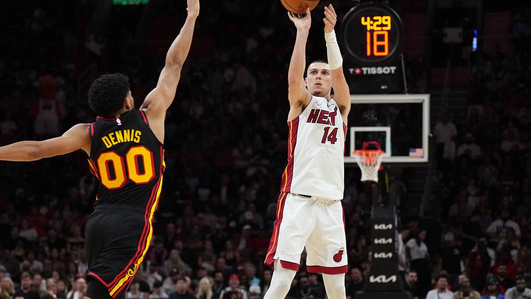 Apr 12, 2026; Miami, Florida, USA;  Miami Heat guard Tyler Herro (14) shoots over Atlanta Hawks guard Rayj Dennis (00) during the second half at Kaseya Center. Mandatory Credit: Jim Rassol-Imagn Images