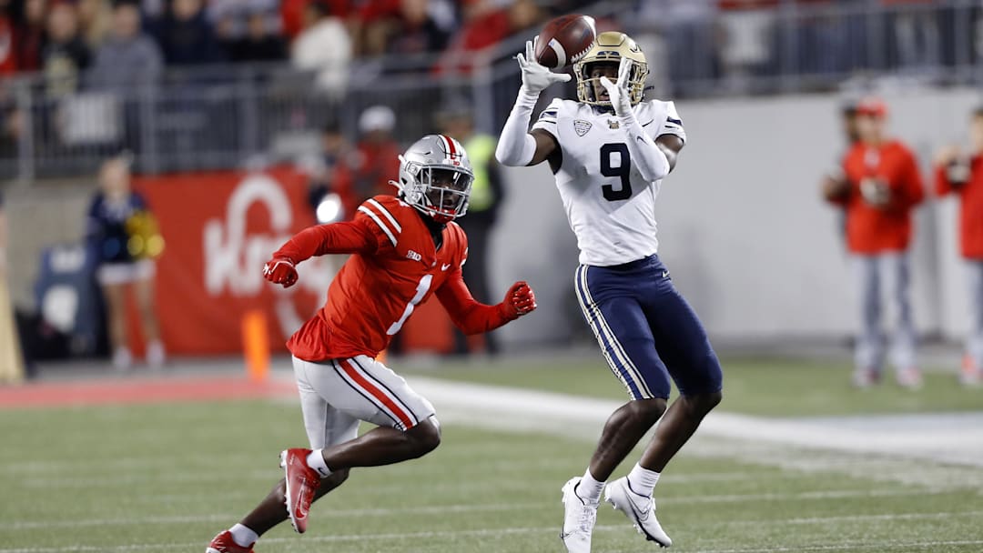 Sep 25, 2021; Columbus, Ohio, USA; Akron Zips wide receiver Konata Mumpfield (9)with the catch as he is defended by Ohio State Buckeyes cornerback Demario McCall (1)during the third quarter at Ohio Stadium. Mandatory Credit: Joseph Maiorana-USA TODAY Sports