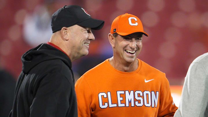 Louisville football coach Jeff Brohm and Clemson Tigers head coach Dabo Swinney talk before the game against Clemson at L&N Stadium Friday, Nov. 14, 2025.