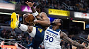 Indiana Pacers forward Aaron Nesmith and Minnesota Timberwolves forward Julius Randle (30) fight for a rebound in the first half at Gainbridge Fieldhouse in Indianapolis on March 24, 2025.