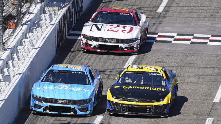 Apr 7, 2024; Martinsville, Virginia, USA; NASCAR Cup Series driver Corey LaJoie (7) and driver Justin Haley (51) battle down the front stretch during the Cook Out 400 at Martinsville Speedway. Mandatory Credit: Jim Dedmon-USA TODAY Sports