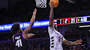 Feb 22, 2025; Cincinnati, Ohio, USA; Cincinnati Bearcats guard Jizzle James (2) shoots against TCU Horned Frogs guard Jace Posey (41) in the first half at Fifth Third Arena. Mandatory Credit: Katie Stratman-Imagn Images