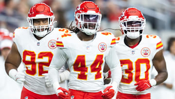 Kansas City Chiefs linebacker Cam Jones (44) with defensive tackle Marlon Tuipulotu (92) and running back Brashard Smith (30) against the Arizona Cardinals during a preseason NFL game at State Farm Stadium.