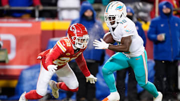 Miami Dolphins wide receiver Tyreek Hill (10) runs the ball ahead of Kansas City Chiefs cornerback Trent McDuffie (22) during the first half of the 2024 AFC wild card game at GEHA Field at Arrowhead Stadium. 