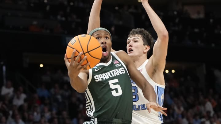 March 23, 2024, Charlotte, NC, USA; Michigan State Spartans guard Tre Holloman (5) shoots against North Carolina Tar Heels guard Cormac Ryan (3) in the second round of the 2024 NCAA Tournament at the Spectrum Center. Mandatory Credit: Bob Donnan-USA TODAY Sports