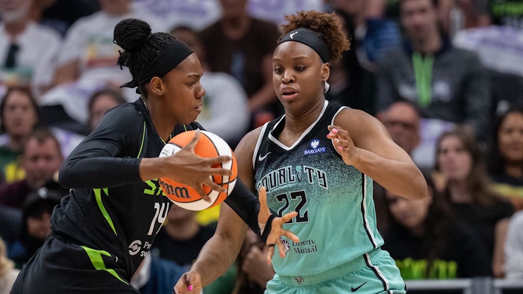Sep 5, 2025; Seattle, Washington, USA;  Seattle Storm center Dominique Malonga (14) drives to the basket bainst New York Liberty forward Kennedy Burke (22) during the first half at Climate Pledge Arena. Mandatory Credit: Stephen Brashear-Imagn Images