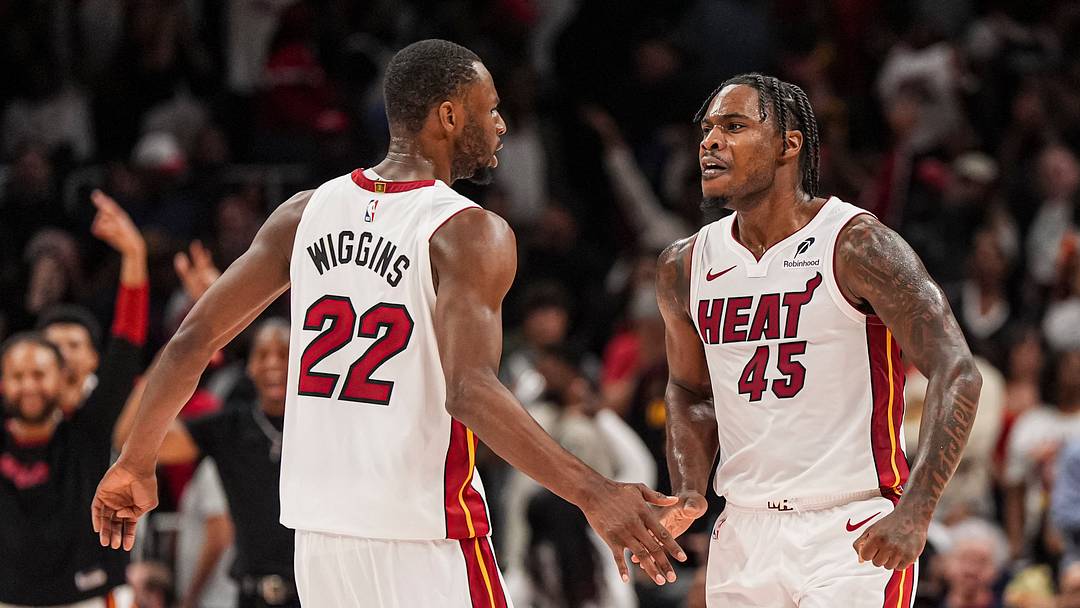 Apr 18, 2025; Atlanta, Georgia, USA; Miami Heat guard Davion Mitchell (45) reacts with forward Andrew Wiggins (22) after the Heat defeated the Atlanta Hawks in overtime at State Farm Arena. Mandatory Credit: Dale Zanine-Imagn Images