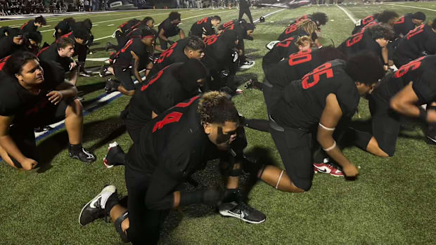 Euless Trinity football players do a ceremonial dance before a Texas high school football game. 