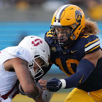 California linebacker Teddye Buchanan tackles Stanford quarterback Ashton Daniels.