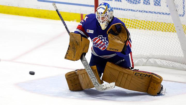Rochester goalie Devon Levi makes the save on this shot against Laval .