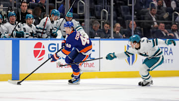 Oct 21, 2025; Elmont, New York, USA; New York Islanders defenseman Matthew Schaefer (48) skates with the puck against San Jose Sharks center Macklin Celebrini (71) during the second period at UBS Arena. Mandatory Credit: Brad Penner-Imagn Images