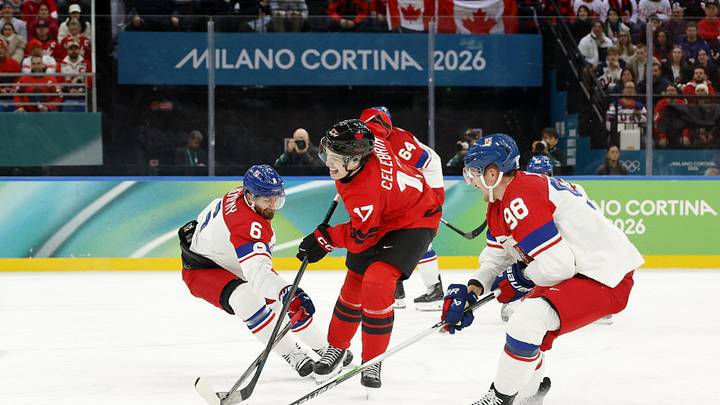 Feb 18, 2026; Milan, Italy; Macklin Celebrini of Canada battles for the puck against Michal Kempny and Martin Necas of Czechia in a men's ice hockey quarterfinal during the Milano Cortina 2026 Olympic Winter Games at Milano Santagiulia Ice Hockey Arena. Mandatory Credit: Geoff Burke-Imagn Images