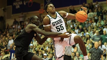 Nov 25, 2024; Lahaina, Hawaii, USA;  Colorado Buffaloes forward Bangot Dak (8) fouls Michigan State Spartans guard Tre Holloman (5) in the second half of an NCAA college basketball game at Lahaina Civic Center. Mandatory Credit: Marco Garcia-Imagn Images