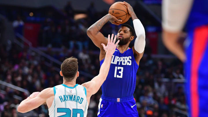 Dec 26, 2023; Los Angeles, California, USA; Los Angeles Clippers forward Paul George (13) shoots against Charlotte Hornets forward Gordon Hayward (20) during the second half at Crypto.com Arena. Mandatory Credit: Gary A. Vasquez-USA TODAY Sports