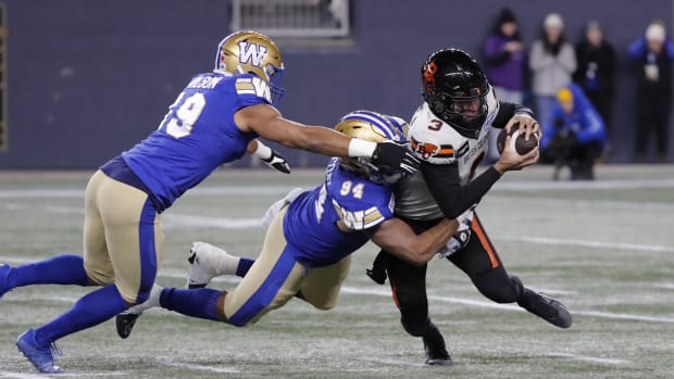 Nov 11, 2023; Winnipeg, Manitoba, CAN;  BC Lions quarterback Vernon Adams Jr. (3) is tackled from behind by Winnipeg Blue Bombers defensive end Jackson Jeffcoat (94) during the first half of the game at IG Field. Mandatory Credit: Bruce Fedyck-USA TODAY Sports