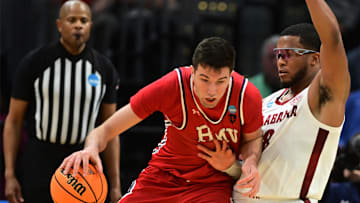 Mar 21, 2025; Cleveland, OH, USA; Robert Morris Colonials forward Alvaro Folgueiras (7) plays the ball defense day Alabama Crimson Tide guard Chris Youngblood (8) in the second half during the NCAA Tournament First Round at Rocket Arena. Mandatory Credit: Ken Blaze-Imagn Images