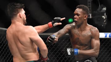 Apr 13, 2019; Atlanta, GA, USA; Kelvin Gastelum (red gloves) fights Israel Adesanya (blue gloves) during UFC 236 at State Farm Arena. Adesanya won by unanimous decision. Mandatory Credit: John David Mercer-Imagn Images
