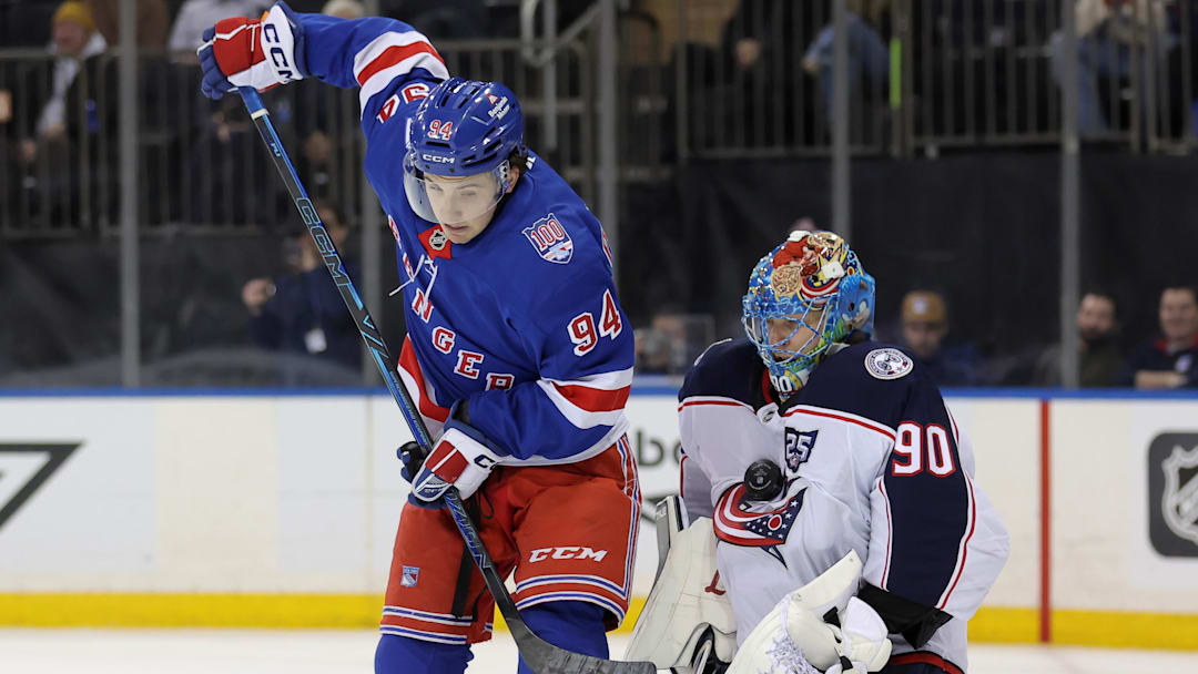Mar 2, 2026; New York, New York, USA; Columbus Blue Jackets goaltender Elvis Merzlikins (90) makes a save in front of New York Rangers right wing Gabe Perreault (94) during the second period at Madison Square Garden.