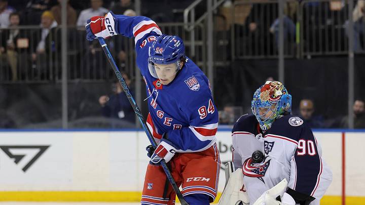 Mar 2, 2026; New York, New York, USA; Columbus Blue Jackets goaltender Elvis Merzlikins (90) makes a save in front of New York Rangers right wing Gabe Perreault (94) during the second period at Madison Square Garden.