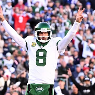 New York Jets quarterback Aaron Rodgers (8) reacts after throwing for a touchdown against the New England Patriots during the second half at Gillette Stadium.