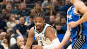 Mar 13, 2024; Orlando, Florida, USA;  Brooklyn Nets guard Dennis Smith Jr. (4) dribbles the ball against Orlando Magic forward Franz Wagner (22) in the second quarter at Kia Center. Mandatory Credit: Jeremy Reper-Imagn Images