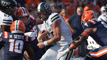 Oct 12, 2024; Champaign, Illinois, USA;  Purdue Boilermakers quarterback Ryan Browne (15) runs with the ball in the first half against the Illinois Fighting Illini at Memorial Stadium. Mandatory Credit: Ron Johnson-Imagn Images