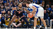 Dec 4, 2024; Durham, North Carolina, USA; Duke Blue Devils forward Cooper Flagg (2) controls the ball in front of Auburn Tigers center Johni Broome (4) during the first half at Cameron Indoor Stadium. Mandatory Credit: Rob Kinnan-Imagn Images