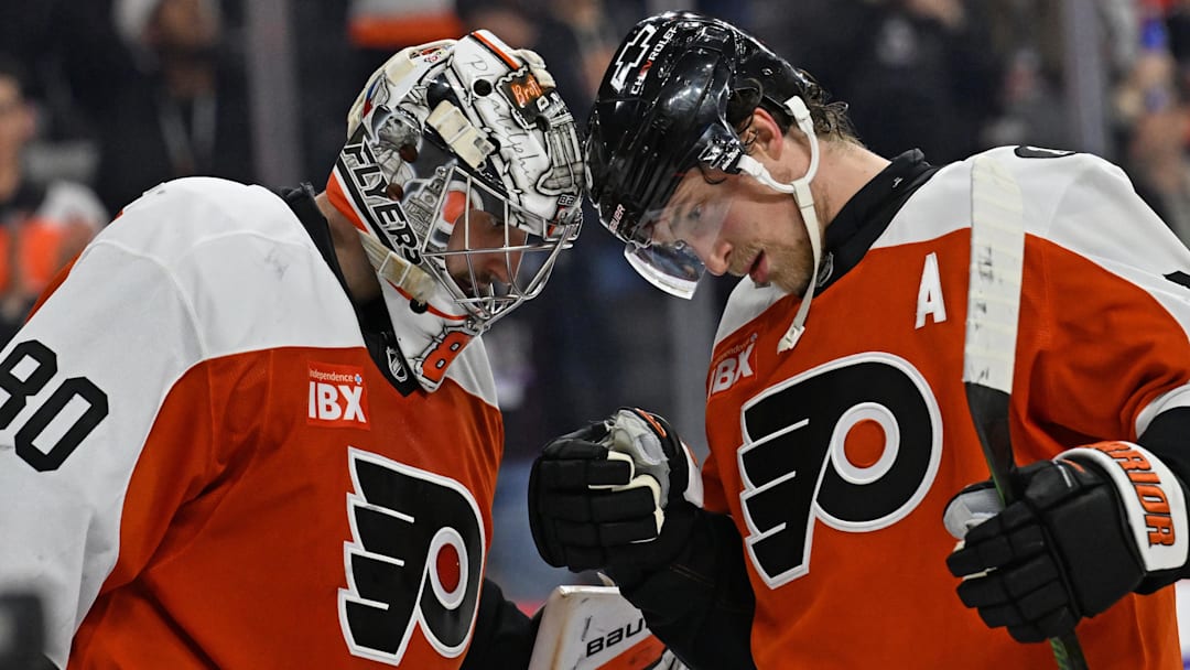 Dec 22, 2025; Philadelphia, Pennsylvania, USA; Philadelphia Flyers goaltender Dan Vladar (80) and Philadelphia Flyers defenseman Travis Sanheim (6) celebrate win against the Vancouver Canucks at Xfinity Mobile Arena. 