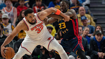 Mar 15, 2025; San Francisco, California, USA; New York Knicks center Karl-Anthony Towns (32) controls the basketball against Golden State Warriors forward Draymond Green (23) during the third quarter at Chase Center. Mandatory Credit: Neville E. Guard-Imagn Images
