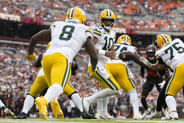 Green Bay Packers quarterback Jordan Love (10) hands the ball to Josh Jacobs at the Browns on Sunday.