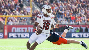 Dec 31, 2024; Orlando, FL, USA; South Carolina Gamecocks quarterback LaNorris Sellers (16) runs the ball against Illinois Fighting Illini linebacker Joe Barna (43) in the first quarter at Camping World Stadium. Mandatory Credit: Jeremy Reper-Imagn Images