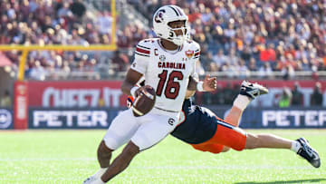 Dec 31, 2024; Orlando, FL, USA; South Carolina Gamecocks quarterback LaNorris Sellers (16) runs the ball against Illinois Fighting Illini linebacker Joe Barna (43) in the first quarter at Camping World Stadium. Mandatory Credit: Jeremy Reper-Imagn Images